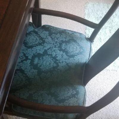 Thre are four side chairs and two arm chairs that go with the dining room table, they are ROSEWOOD ASIAN DINING Chairs