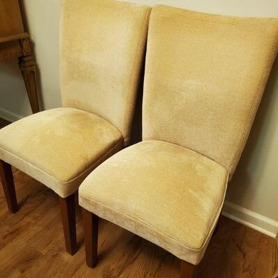 Pair of matching yellow fabric dining chairs with wooden legs. 18x19x39" seat height 18" Pet free and smoke free home....