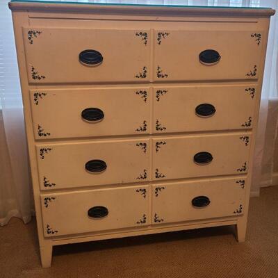Beautiful white four drawer dresser with painted on ivy. In good condition, measures 36" x 17" x 40". Drawers measure...