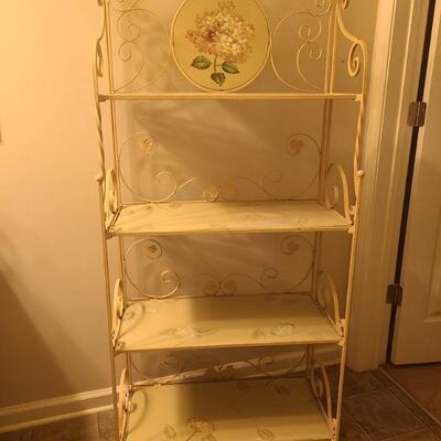Shelf frame is made of metal and painted a cream color. Shelves and round decorative piece are made from wood. Shelves can be pushed up...