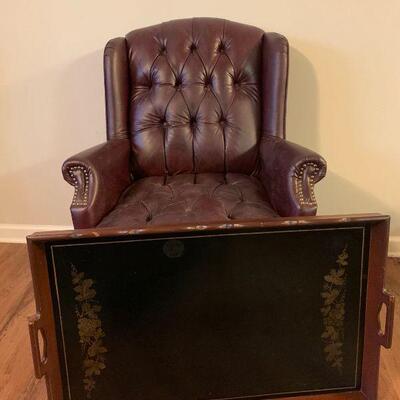 This Queen Anne chair comes with wooden serving tray and features oxblood fabric and has brass stud accents. The serving tray has a...