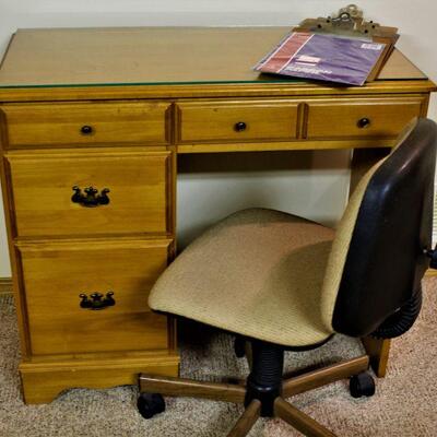 Small oak office desk with separate office chair.