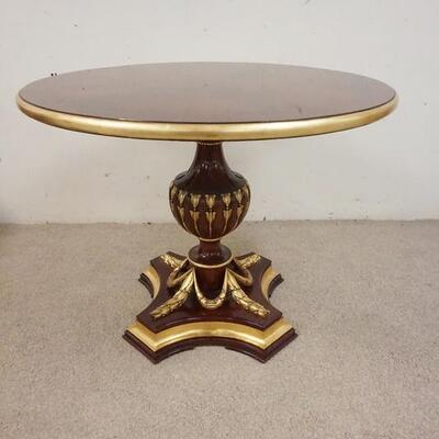 1004	MAHOGANY TABLE ON URN SHAPED PEDESTAL HAS CARVED SWAG W/ GILT ACCENTS. 40 IN X 30 IN 
