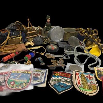 This lot contains a variety of Boy Scout Memorabilia. It contains pins, compass, badges, a statue, belts, and a utility knife....