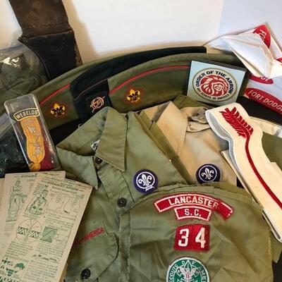 Two vintage Boy Scout shirts along with a pair of pants (Youth Large), three hats, patches, socks, suspenders, and knife carrier(11â€)....