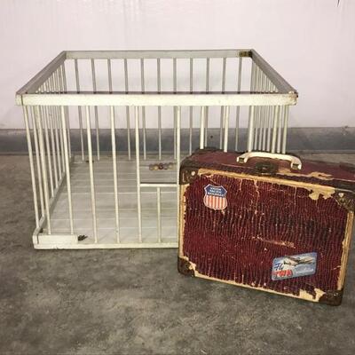 This lot contains a vintage playpen measuring 12â€ x 19â€ and a vintage childrenâ€™s travel case with some stains on the inside. The...