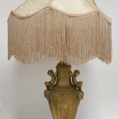 1281	METAL LAMP W/CHERUB HANDLES, PAINTED GOLD, BROCADE CLOTH SHADE W/FRINGE, 36 IN HIGH
