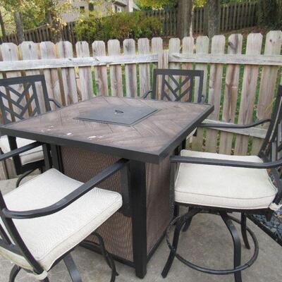 Bar height table with fire pit and four chairs