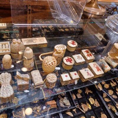 Brass charms made from recycled bullet shell casings local artists.