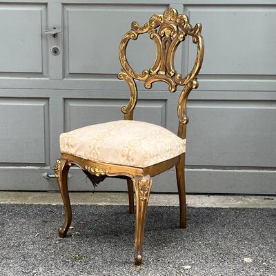 PAIR GILT CHAIRS | Fancy accent chairs, including an armchair (37 x 25 x 26 in.) and a side chair, each with highly carved backrests with...