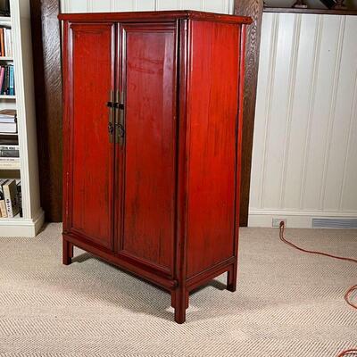 CHINESE LACQUERED CABINET | Red lacquered cabinet, with double doors opening to reveal two drawers between open shelves, with brass...