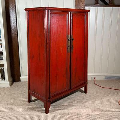 CHINESE LACQUERED CABINET | Red lacquered cabinet, with double doors opening to reveal two drawers between open shelves, with brass...