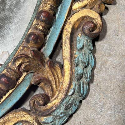 ANTIQUE PAINTED MIRROR  | Carved, gilt, and polychrome framed oval wall mirror with Rococo decorations, h. 30 x 18 in.