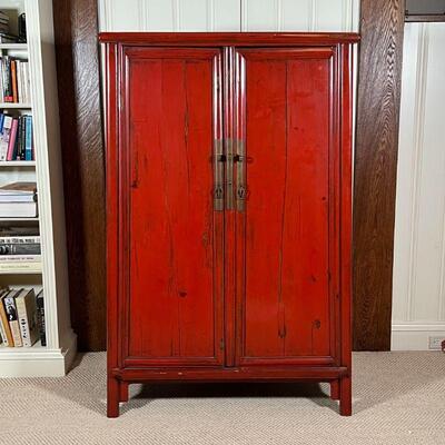 CHINESE LACQUERED CABINET | Red lacquered cabinet, with double doors opening to reveal two drawers between open shelves, with brass...