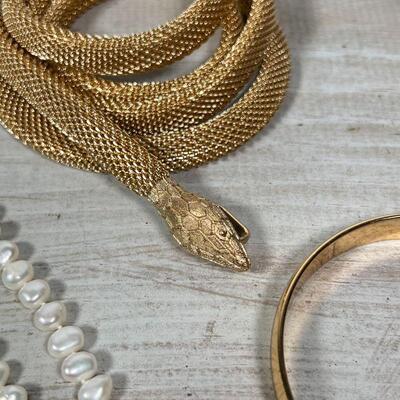 COSTUME JEWELRY | Including a snake-form necklace, a choker, gold-toned bracelets, a lucky four leaf clover pin, etc.