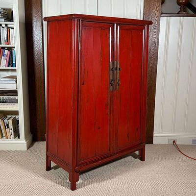 CHINESE LACQUERED CABINET | Red lacquered cabinet, with double doors opening to reveal two drawers between open shelves, with brass...
