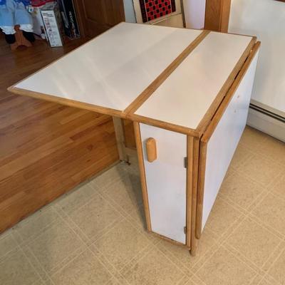 1980â€™s Formica and maple drop leaf storage table w/ 4 chairs on rollers.