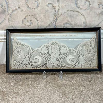 ANTIQUE LACE PANEL  |  Showing a central figure flanked by flowers, framed between glass; w. 18.5 in. - w. 20.25 x h. 9.5 in. (frame)