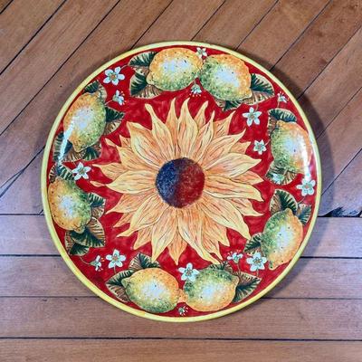 ITALIAN SUNFLOWER CHARGER  |  Showing a sunflower on a red ground within a border of lemons, signed and with wax stamp on verso - dia....