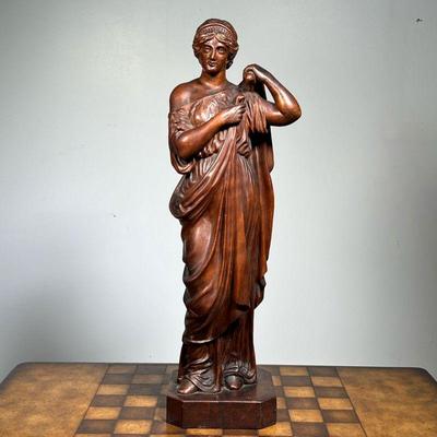 COMPOSITION FIGURE  |  Bronze style composition figure of a woman donning a robe - h. 21 1/4 in.