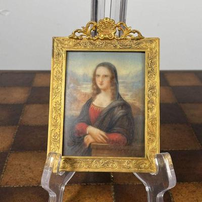 ENAMEL PORTRAIT IN GOLD FRAME  |  Of small size, a reproduction of the Mona Lisa painted on enamel in an antique possibly gold or...