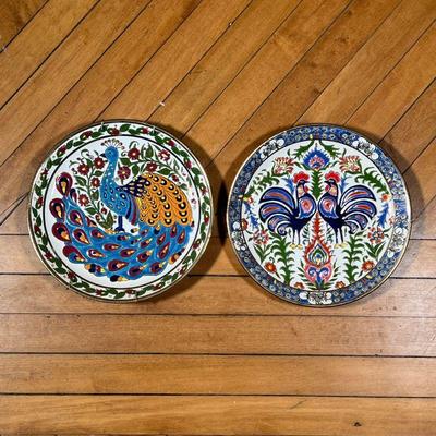 (2pc) GREEK PLATES  |  Greek sculpted pottery plates with hand coloring and gilt highlights, one showing a peacock, the other showing two...
