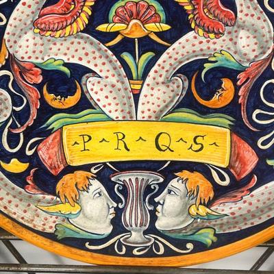 FAIENCE POTTERY CHARGER  |  "PRQS" showing mythical figures / beasts amongst mirrored scrolling foliage, no apparent markings...