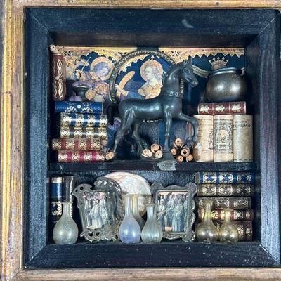 ZACARIA'S MINIATURE BOOKSHELF  |  Shadowbox frame decorated with miniature books, scrolls, a bronze horse glassware, framed prints...