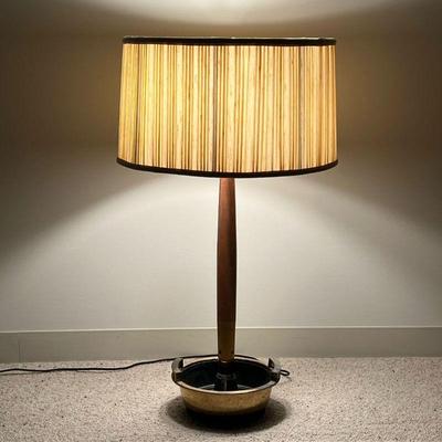 BRASS AND WOOD TABLE LAMP  |  
The lower section having a brass base in with handles and two removable inserts, possibly for planting -...