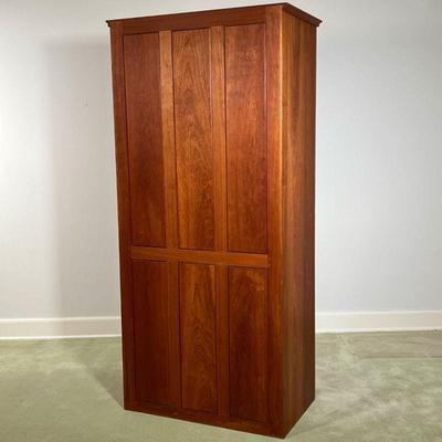 THOMAS MOSER CHERRY CABINET  |  
Having cabinet doors, revealing an interior with adjustable shelves, and hanging rod over for graduated,...