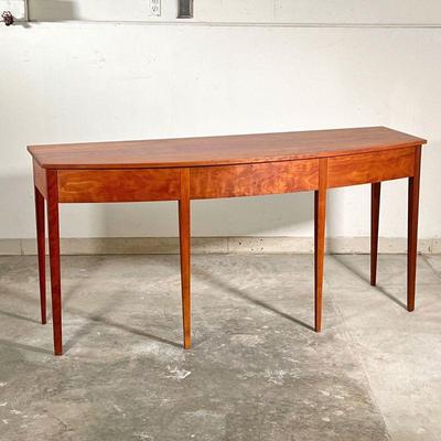 THOMAS MOSER SIDEBOARD  |  
Figured American cherry wood, having a bowed front with three drawers raised on six straight tapering legs -...