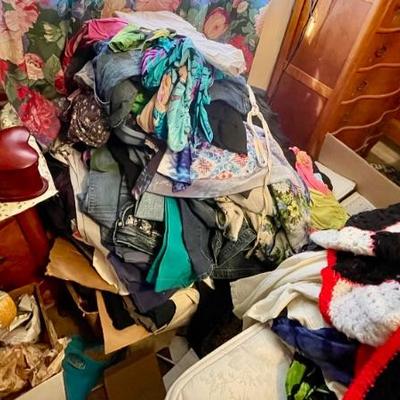 Piles of very nice clothes, some with tags still on them. 