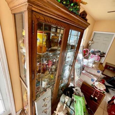 An entire curio cabinet full of Garfield collectibles as well as other cartoon characters 