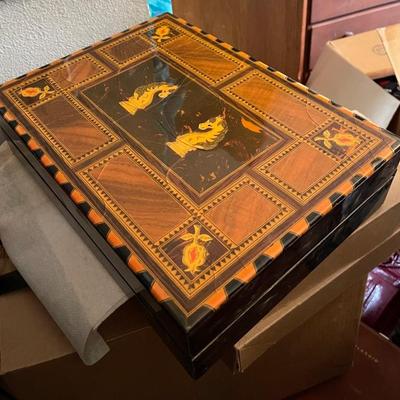 Chess set in lacquered carrying case with magnetic covers so chess pieces donâ€™t fall out when you open it. 