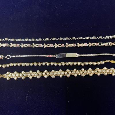 clear stone bracelet, breast cancer bracelet, silver name bracelet, pearl bracelet and pearl and gold tone bracelet