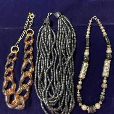 chunky tortoise looped chain necklace, black multi layer beaded necklace, & white, silver, and black bead necklace