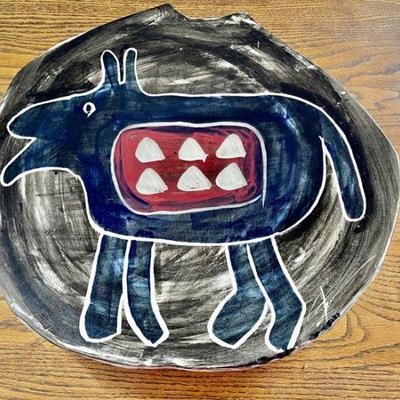 Lot 027-DR: D. O. G. Platter

Features: 
â€¢	Glazed decorative platter signed by artist Doug Stevenson
â€¢	Original price label on...