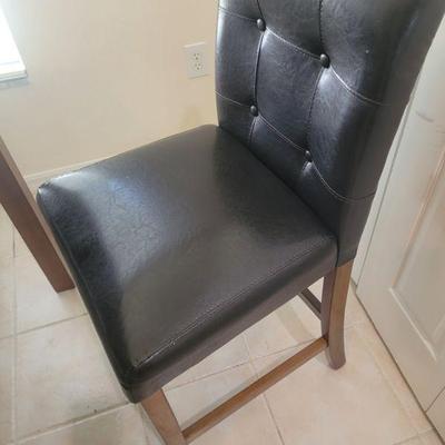 One of the chairs of the nook table and chair set