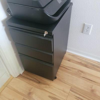 Black file cabinet and a printer