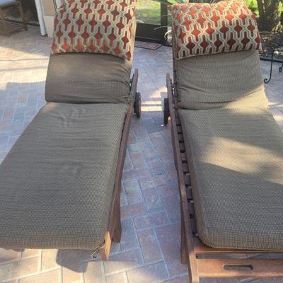 Pair of wooden, cushioned lounge chairs