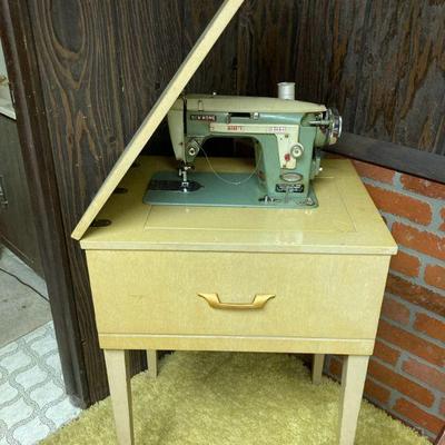 New Home sewing machine in cabinet