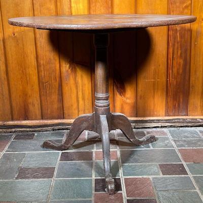 TILT TOP TABLE | Vintage Tilt Top Table in an old finish. Three leg base with turned center post, cabriole legs and pad feet Base pegged...