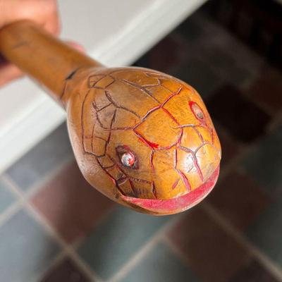 (2PC) FOLK ART WALKING STICKS | Two Walking Sticks: (1) Folk Art Carved Curved Snake with red highlights (1) Carved and Black shaded Knob...