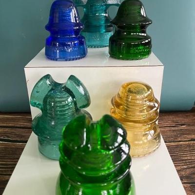 Antique glass electric insulators: lots of colors: carnival glass, marigold, milk glass, black, blue, cobalt, turquoise, amber, green,...