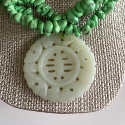 Multi strand green turquoise necklace with an antique jade pendant