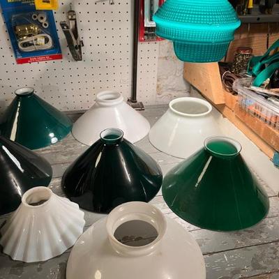 Lots of antique case glass lamp shades in green, milk glass, and red. Do you have an old lamp that needs a period replacement shade?