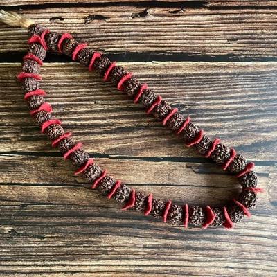 A necklace of Nepalese Rudraksha with red felt, vintage