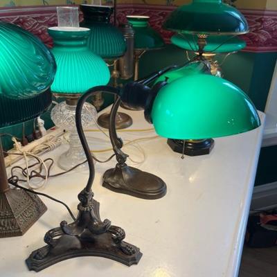 A large selection of antique green case glass lamps and shades, including Handel basesâ€”floor lamps, desk lamps, table lamps