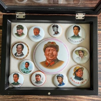 A collection of Chinese Communist porcelain propaganda pins and pendants, featuring Mao, peasants, soldiers and others, dating from...