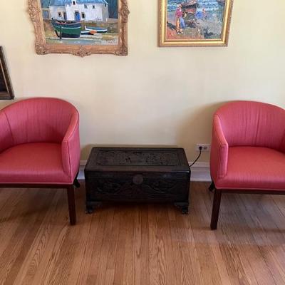 a pair of vintage club style chairs covered in a pretty raspberry red